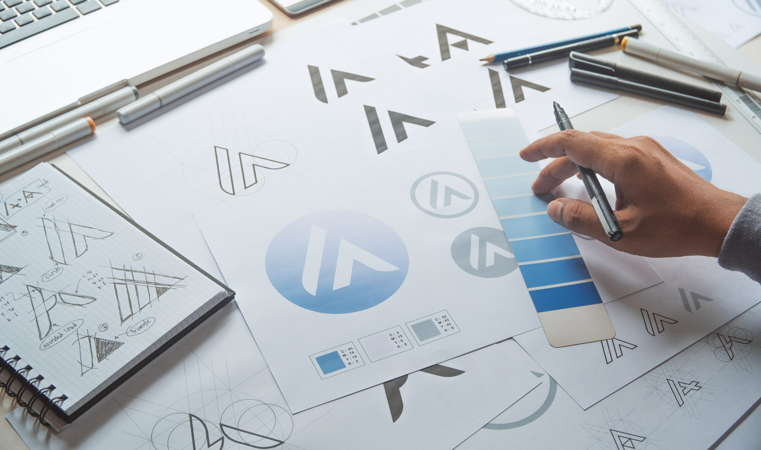Someone working on a branding image looking at a blue color palette