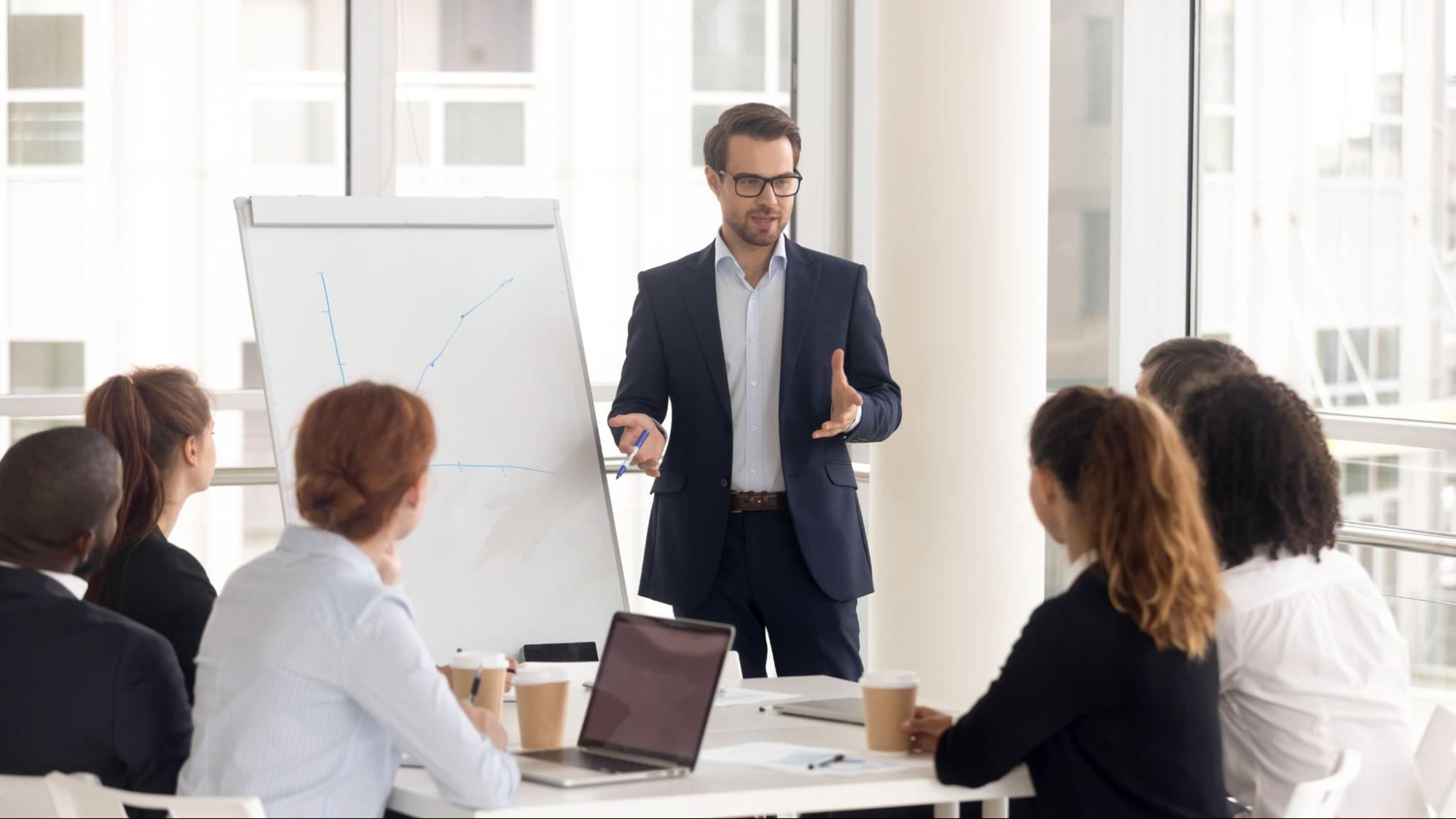 Person leading a meeting in a conference room.